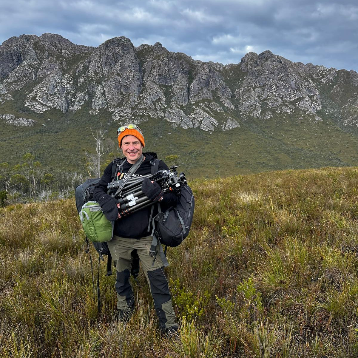 Person with hiking gear standing in a mountainous landscape